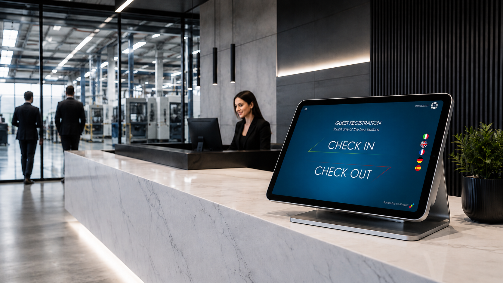 Company reception desk with the IRIGuest tablet on the counter, showing the Check In and Check Out buttons and the language flags