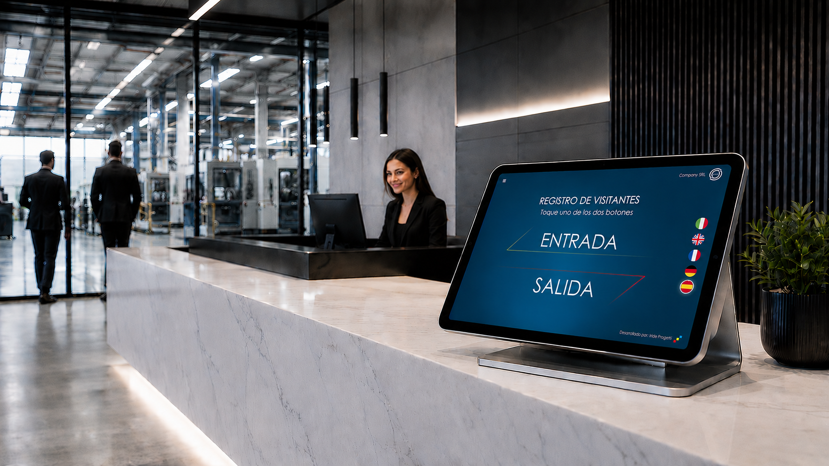 Recepción de empresa con la tablet de IRIGuest sobre el mostrador, pantalla con los botones de entrada y salida y las banderas de los idiomas