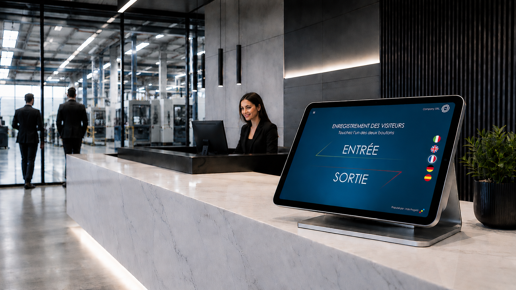 Accueil d’entreprise avec la tablette IRIGuest posée sur le comptoir, écran affichant les boutons d’entrée et de sortie et les drapeaux des langues